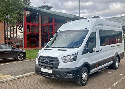 A white Ford Transit Minibus parked outside Middlesbrough FC