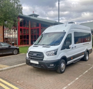 A white Ford Transit Minibus parked outside Middlesbrough FC