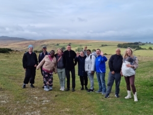 A group of adults standing on a green field