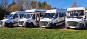 Four Mercedes-Benz accessible vehicles are lined up outside