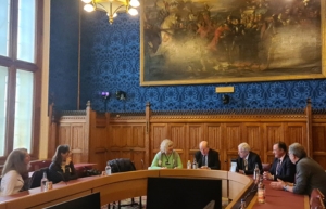 Seven people sitting around a meeting table