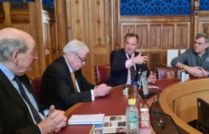 Four people sitting around a meeting table