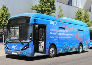 A bus is parked in front of a building at Sky's Osterley campus