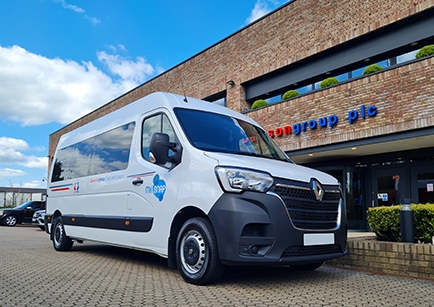 White minibus with an MK SNAP logo parked in front of Dawsongroup HQ