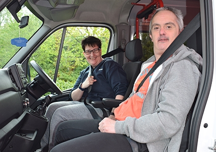 Two people sat inside an accessible minibus