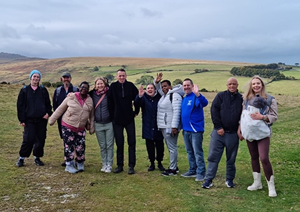 A group of people gathered on a green field.