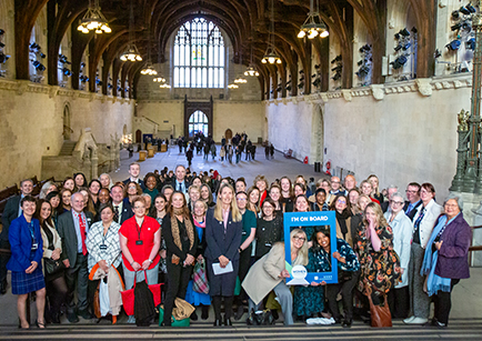 A large group of people standing on a set of stairs in Westminster Palace.