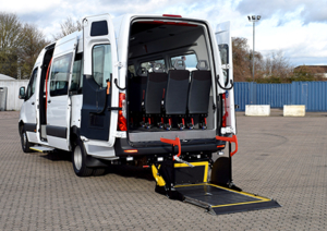 White accessible minibus with wheelchair ramp