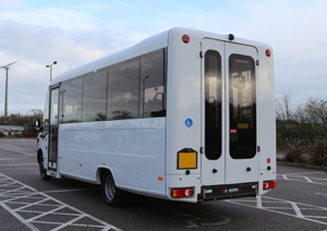 A coachbuilt accessible minibus parked in a parking bay